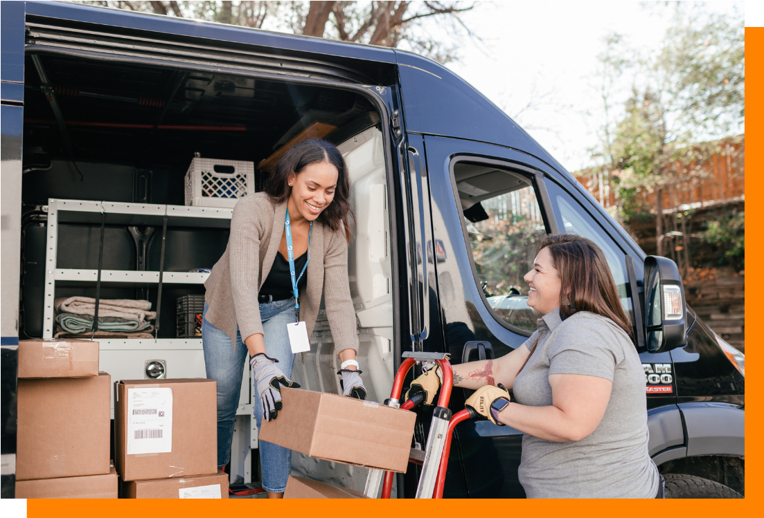 Two women unloading cargo van Two women unloading cargo van